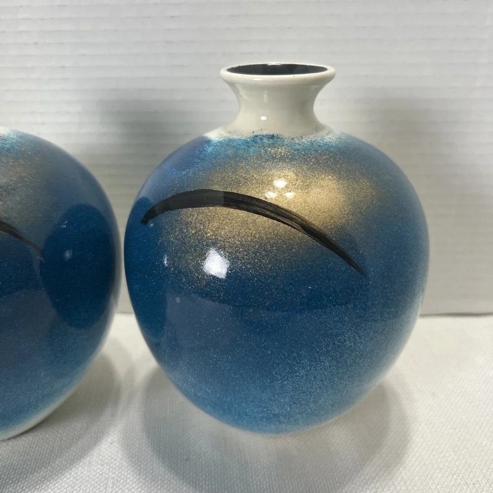 Pair of decorative blue, gold, black and Cream ceramic bottle vases